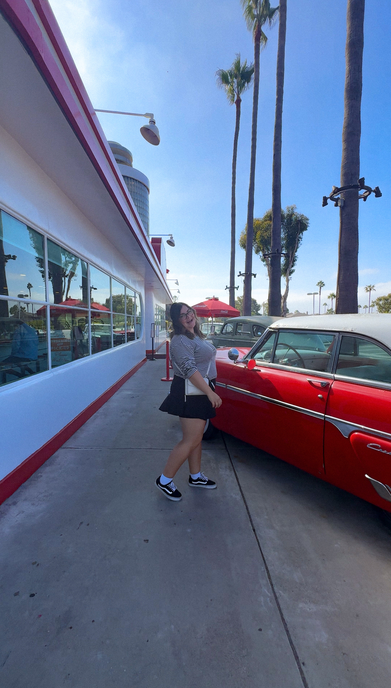 Maria next to a car at Ruby's Diner